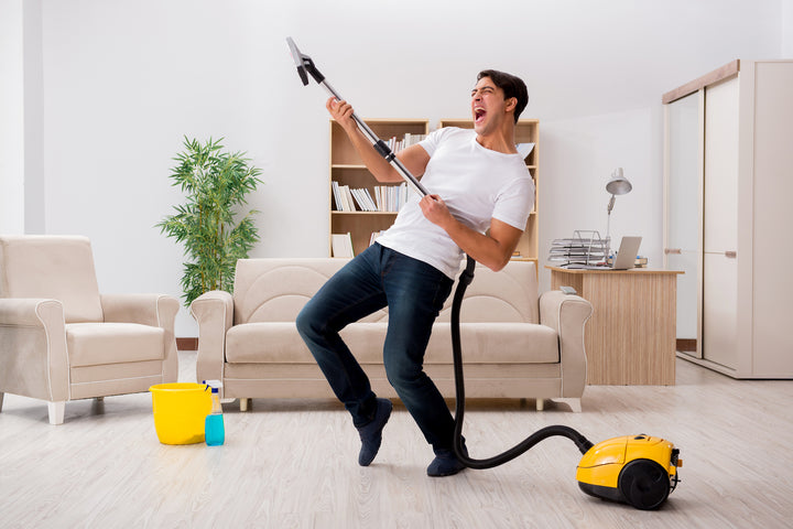 man cleaning home happily
